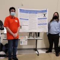 4 people in front of a project